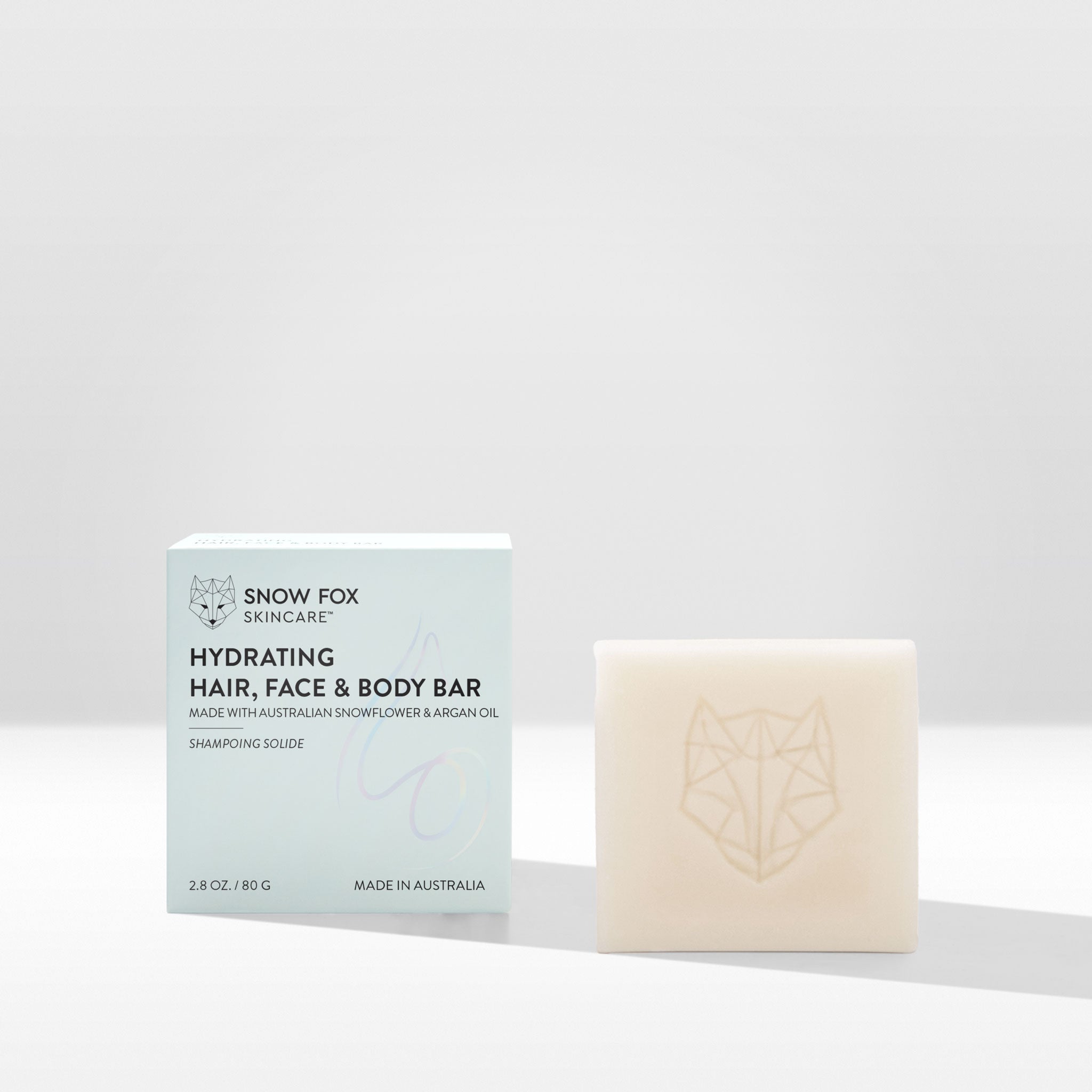 Snow Fox Skincare hydrating hair, face, and body cleansing bar with packaging on a white background