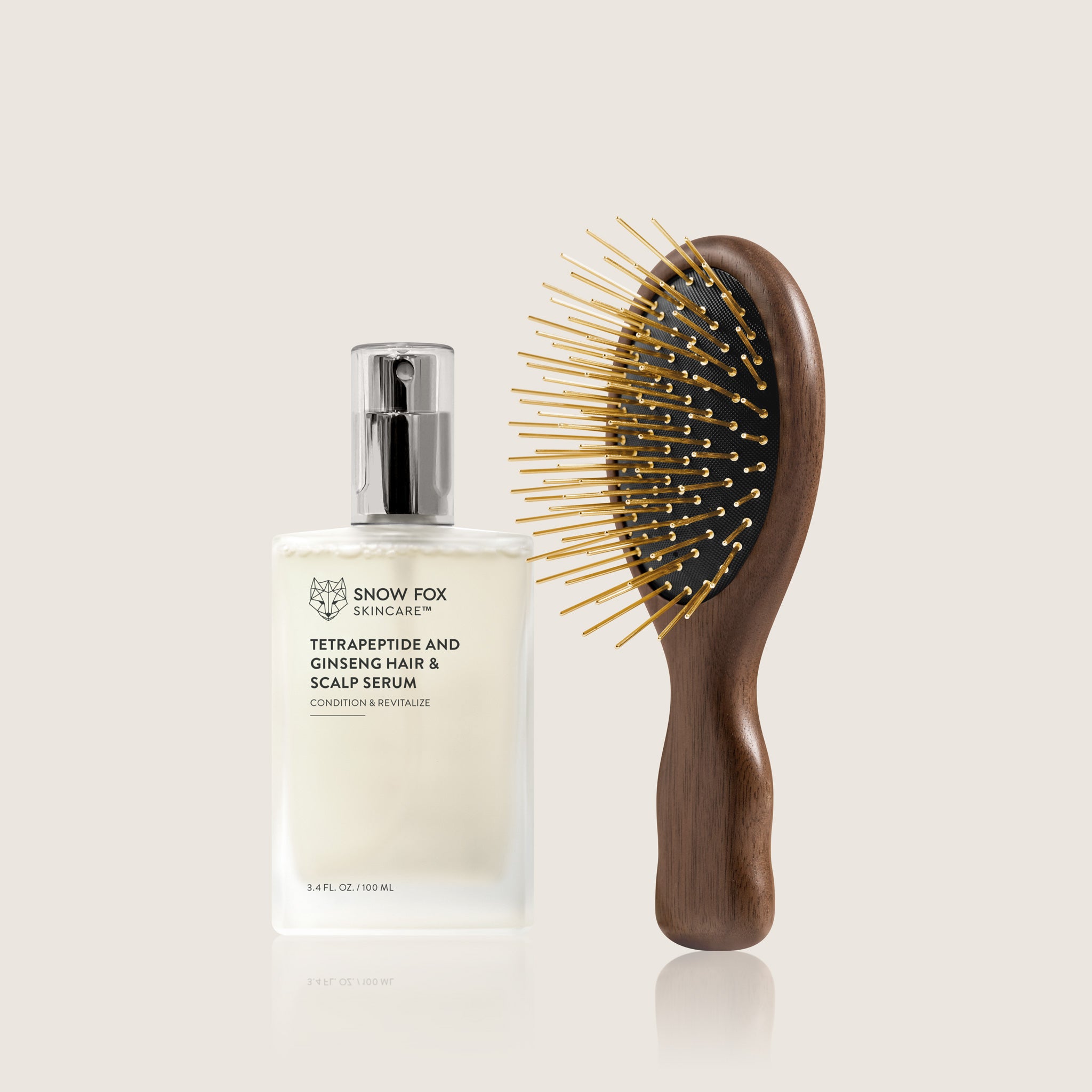 Snow Fox hair serum bottle and the walnut wood Infrared Gua Sha hairbrush with 24K Gold needles, on a light background