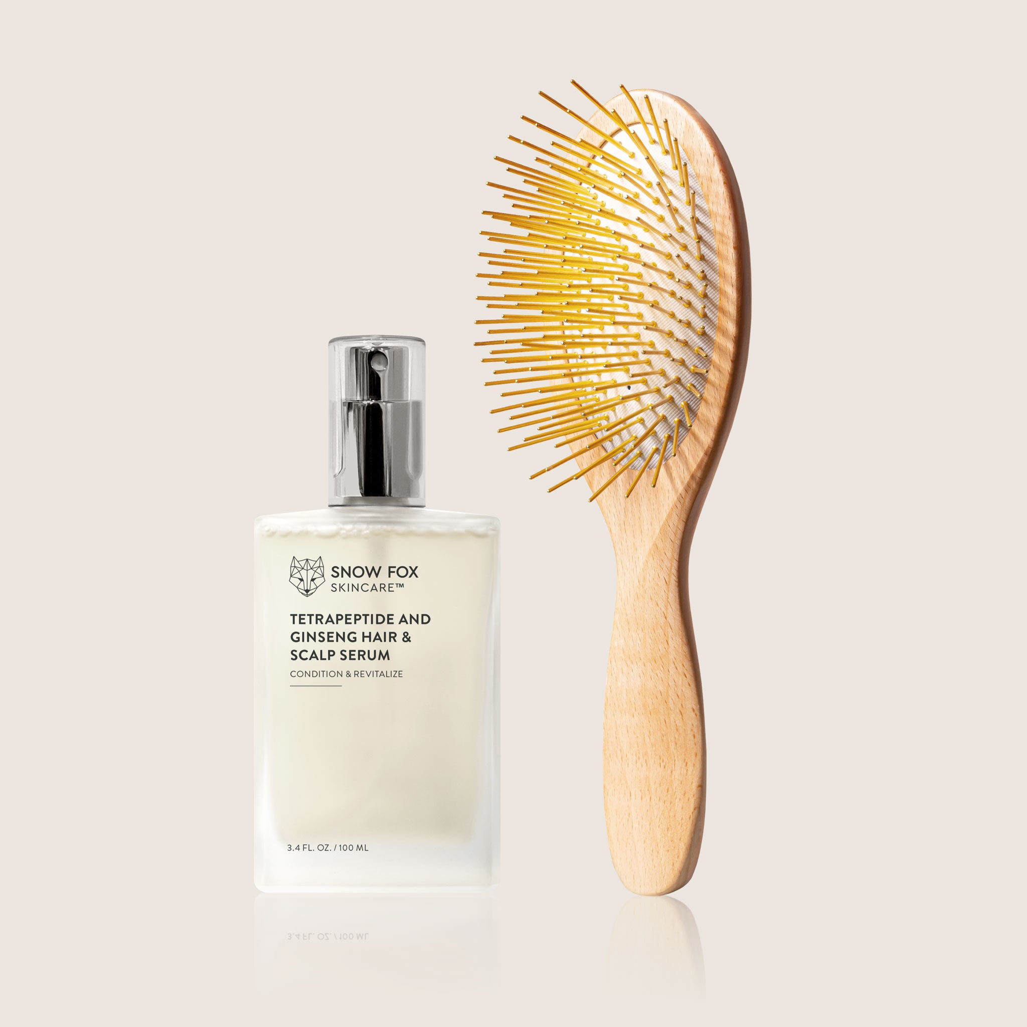 Snow Fox skincare hair serum bottle with a wooden edition Gua Sha brush on a light beige background as a revitalizing set for healthy hair and scalp