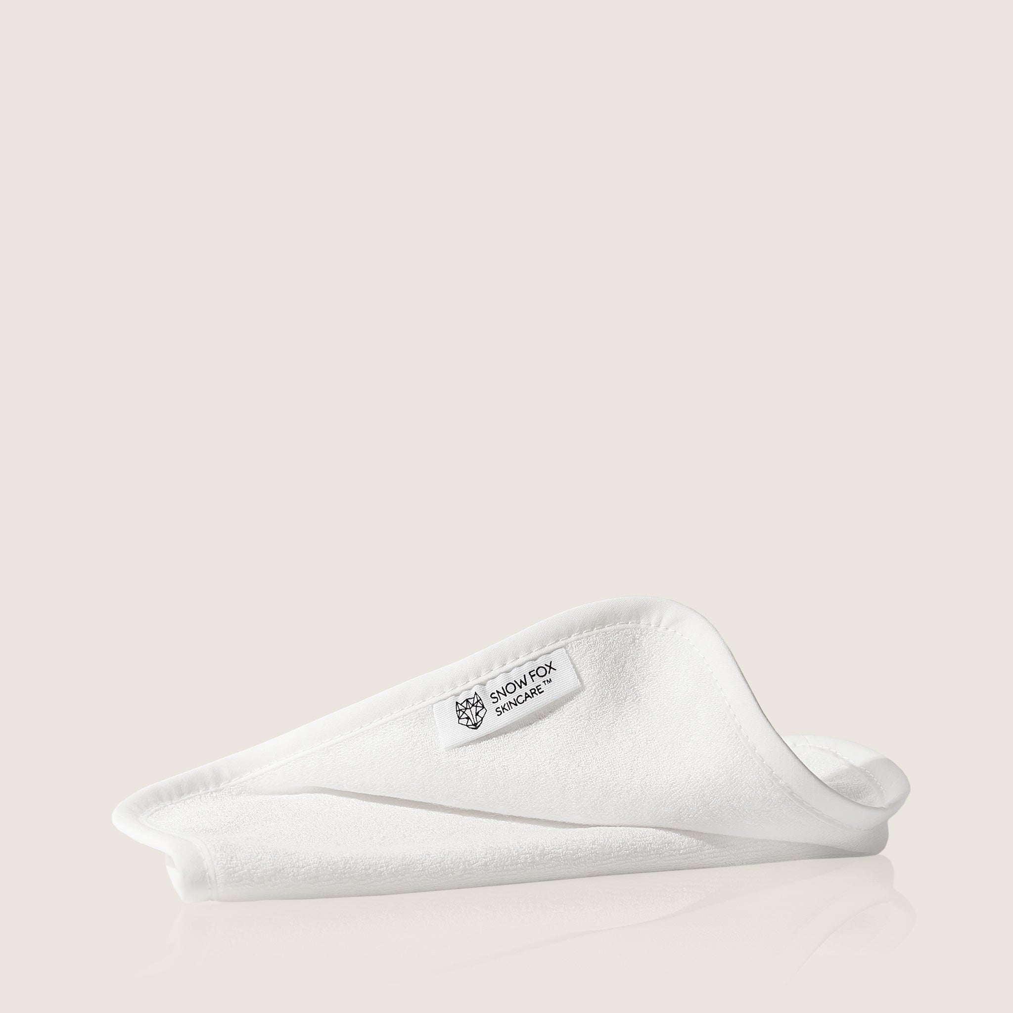 organic Bamboo cotton facial cloth by snow fox skincare on a light beige background