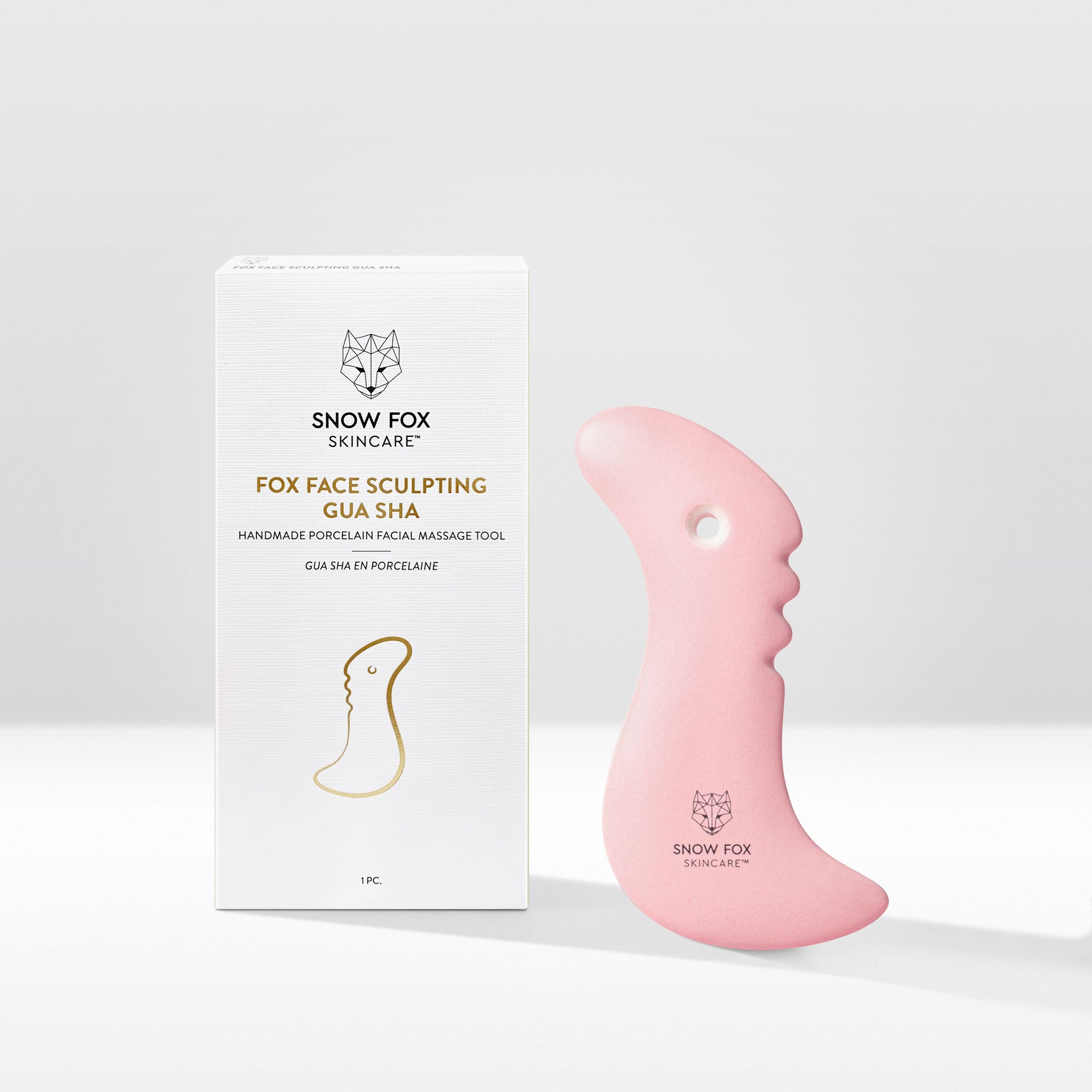 A fine porcelain, facial slimming Gua Sha specially designed by reflexologists to reach lymphatic drainage points under the chin to minimize bloating and sagging, naturally lifting and contouring the face especially around the jawline.