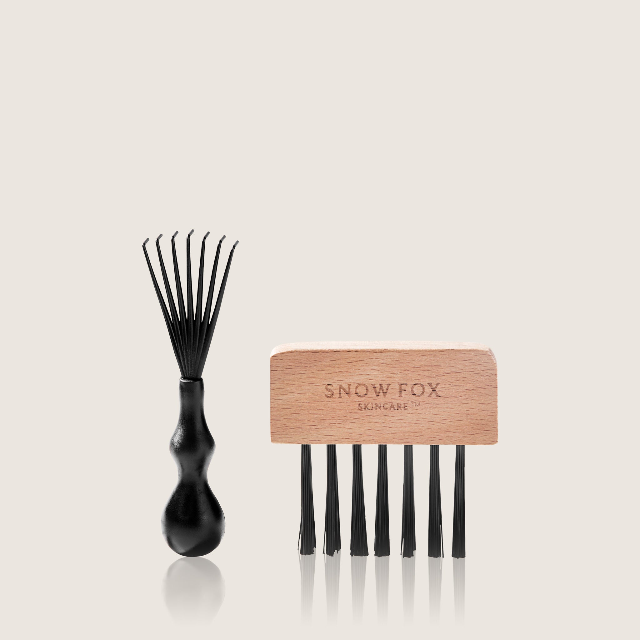 Black cleaning brush and wooden comb  kit with 'Snow Fox Skincare' branding on a beige background 