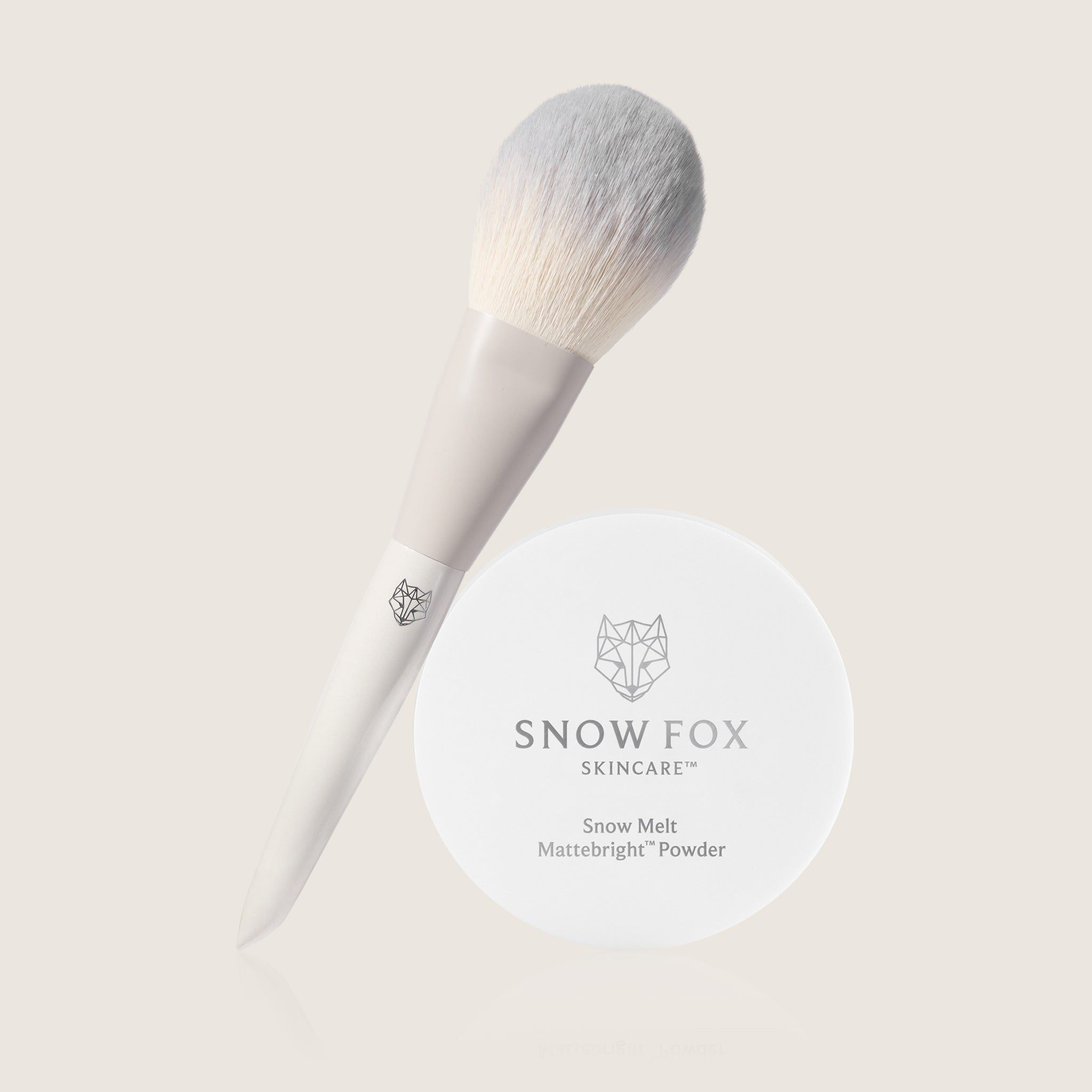 Snow Fox skincare Mattifying powder and Fox tail make up brush on a light background