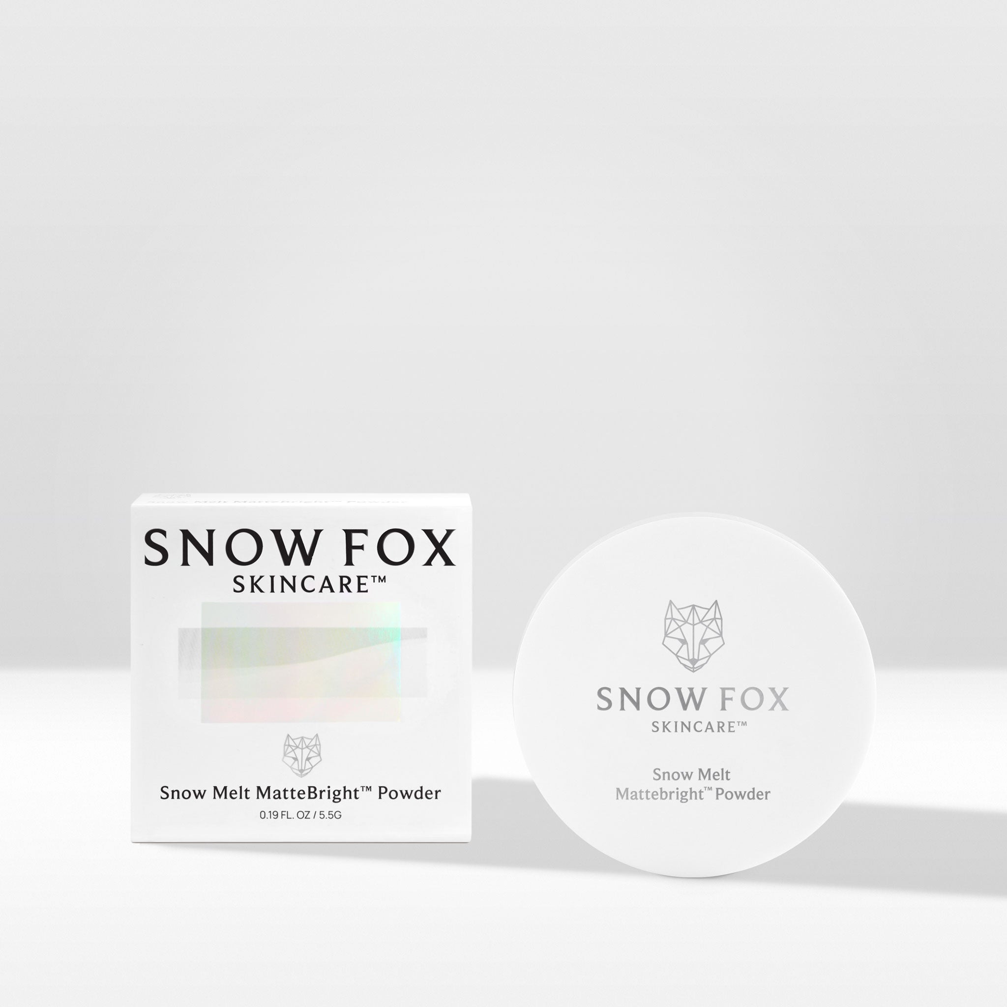 A compact powder labeled 'Snow Melt MatteBright™ Powder' from Snow Fox Skincare, displayed next to its packaging box.