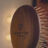 Woman using the Infrared Walnut wood Gua Sha Brush to demo scalp massage and amazing feeling for hair and scalp health improvements by Snow Fox Skincare