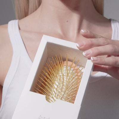 Stimulate acupressure points and promote healthy hair growth with our hand carved 24K gold-plated, premium wooden Gua Sha Hair &amp; Scalp Brush.