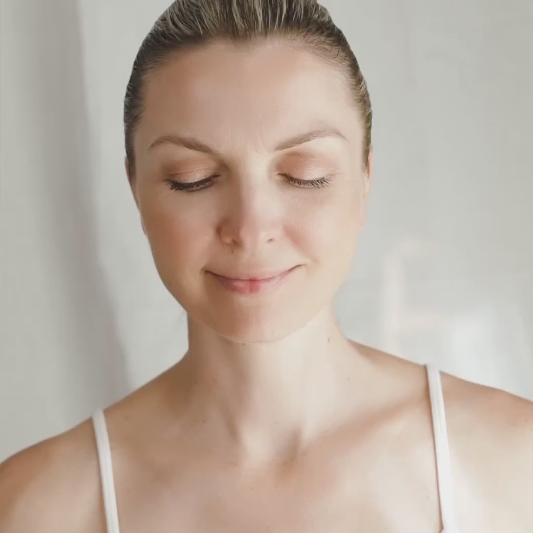 a video of woman using the Ghost Edition Gua Sha Brush by Snow Fox Skincare to demo massage techniques on hair, scalp and arms and neck